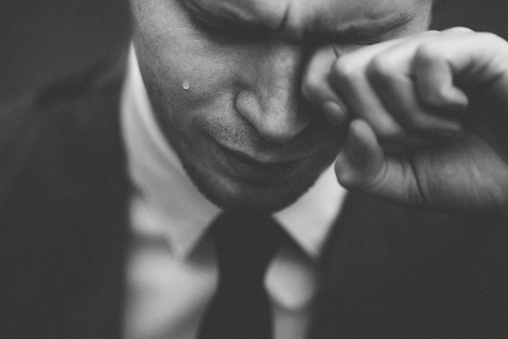 © Photo by Tom Pumford on Unsplash Man weeping in business suit