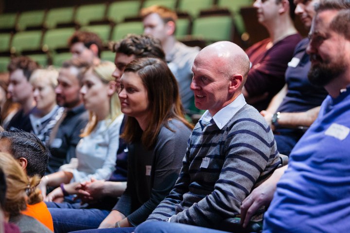 © Helen Murray RADA Business course participants watch a presentation in an auditorium.