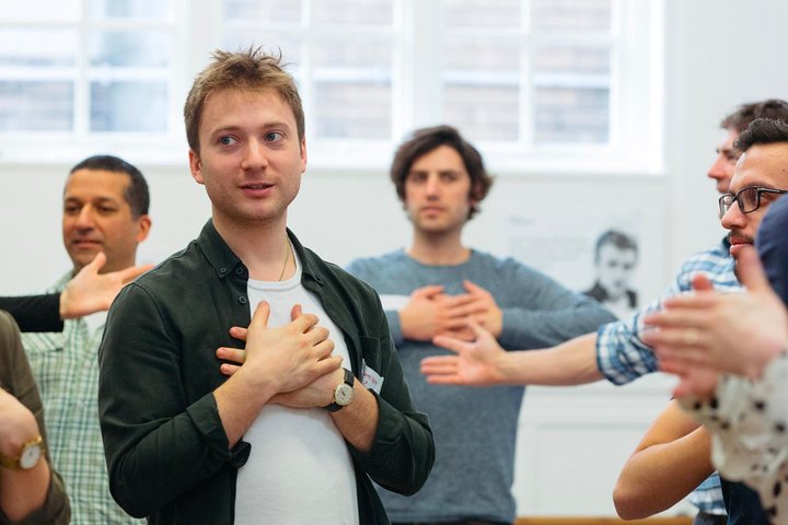 A RADA Business workshop participant holds his heart as he takes part in an exercise