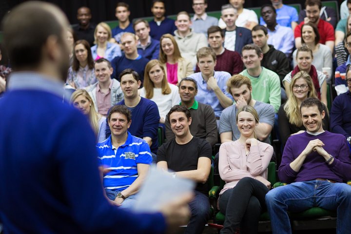 © J Tucker A RADA Business tutor is standing and presenting a speech in a theatre.